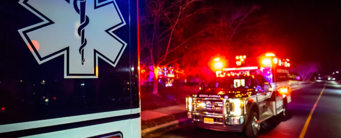 Close up emergency ambulance truck illuminated at night accident response